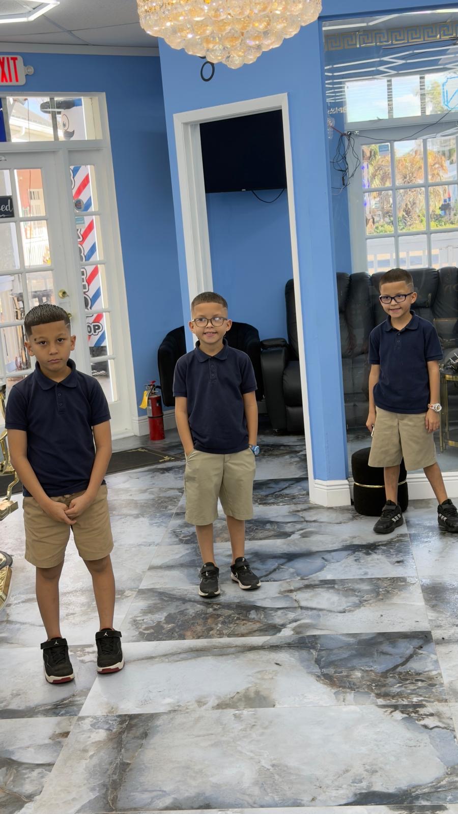 Three children after their visit inside Tonikon barbershop