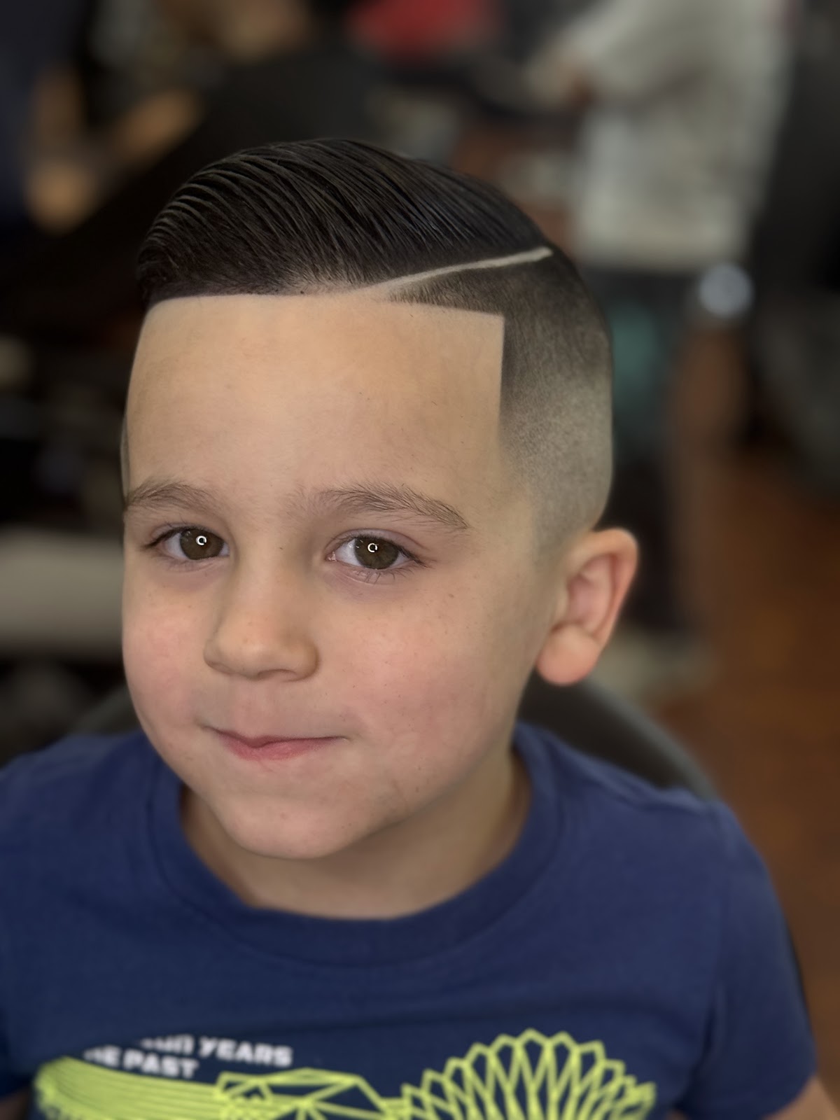 Finished child's haircut with a defined side part