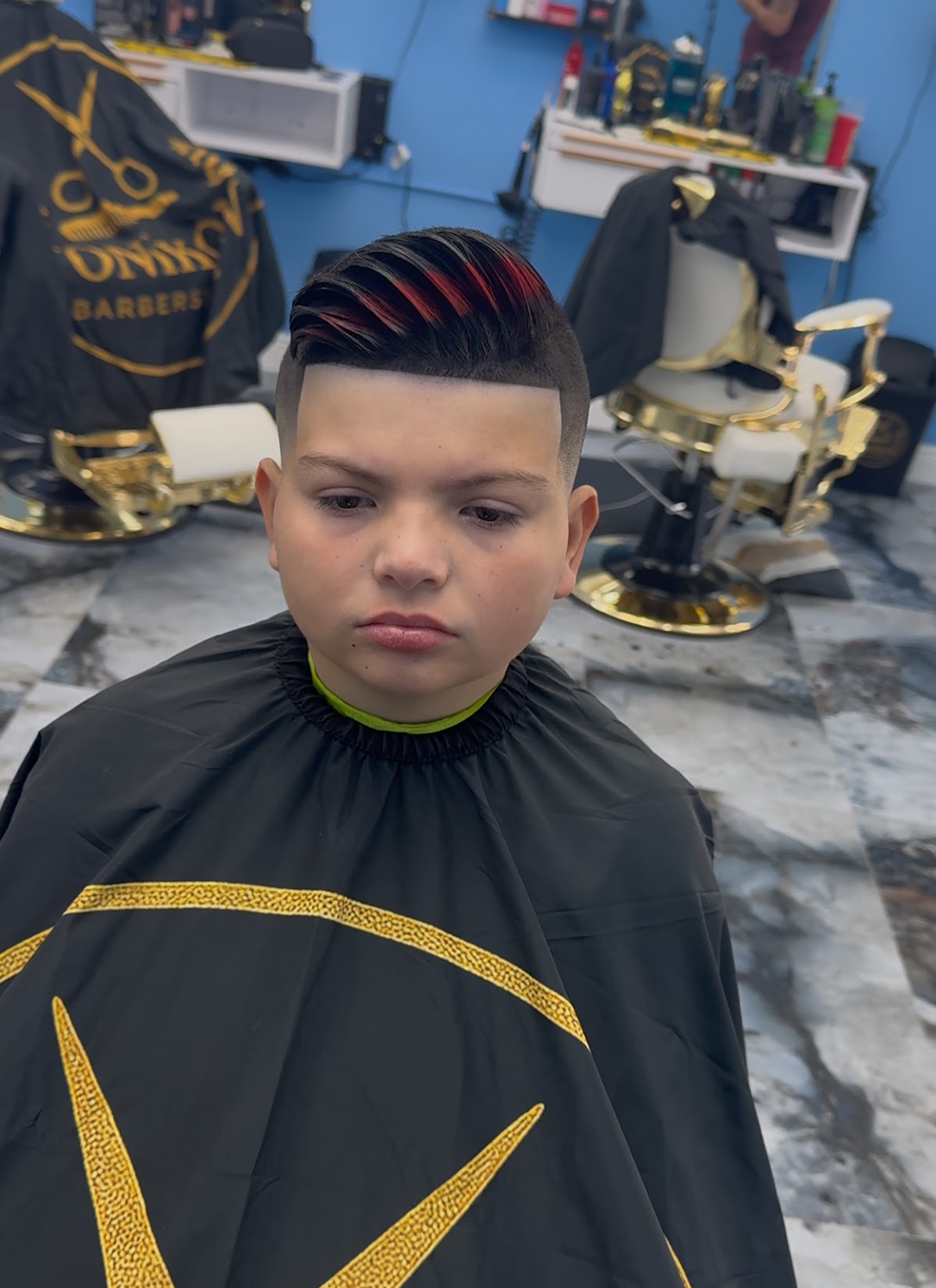 Finished haircut with colored highlights in a Tonikon barber chair